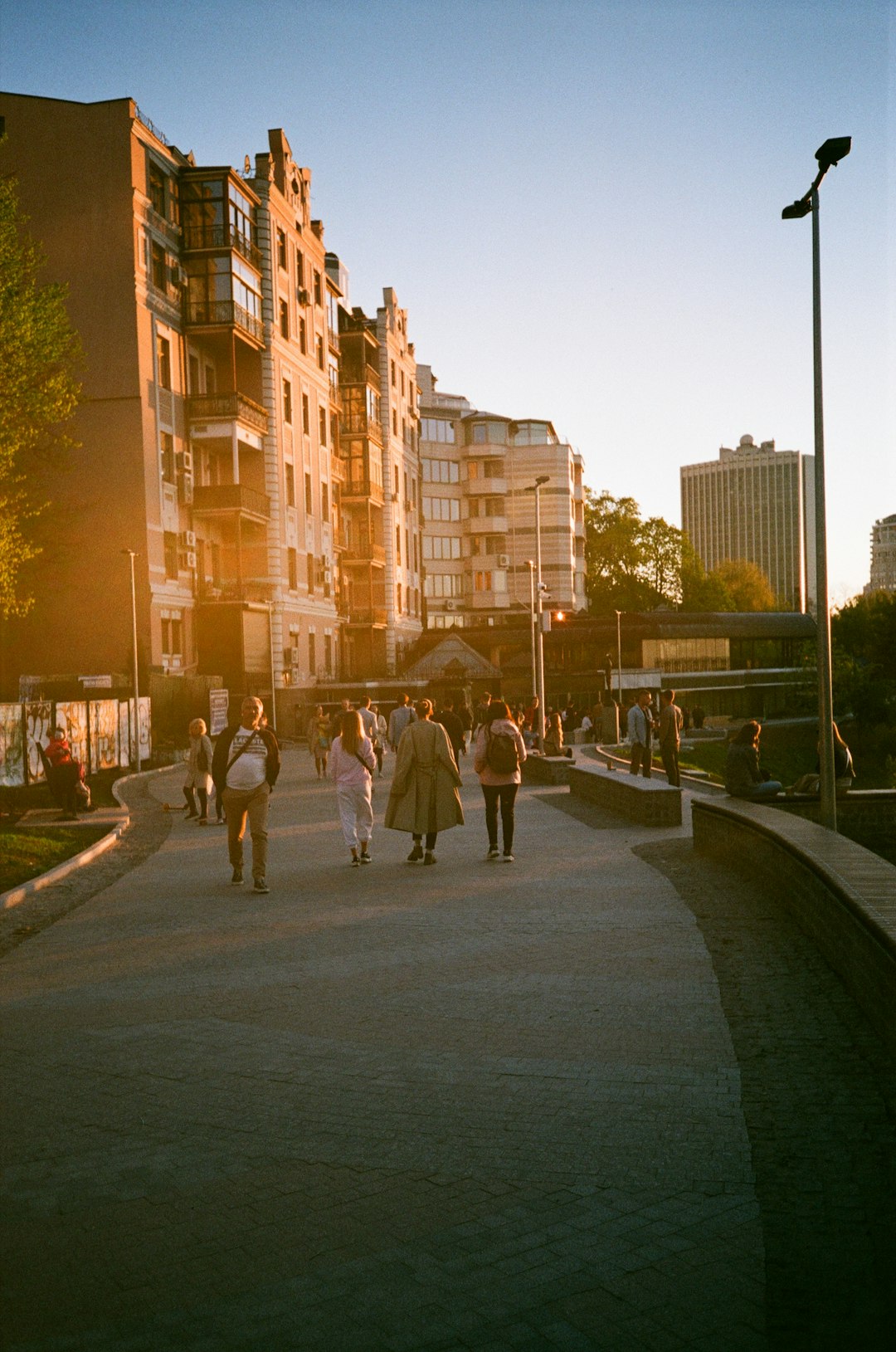 people walking on sidewalk near high rise buildings during daytime