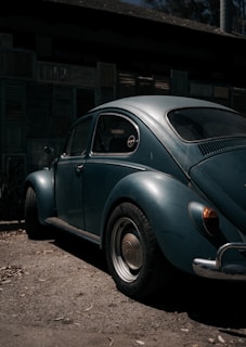 A colorful vintage Volkswagen Beetle parked on a sunny street, showcasing retro charm.