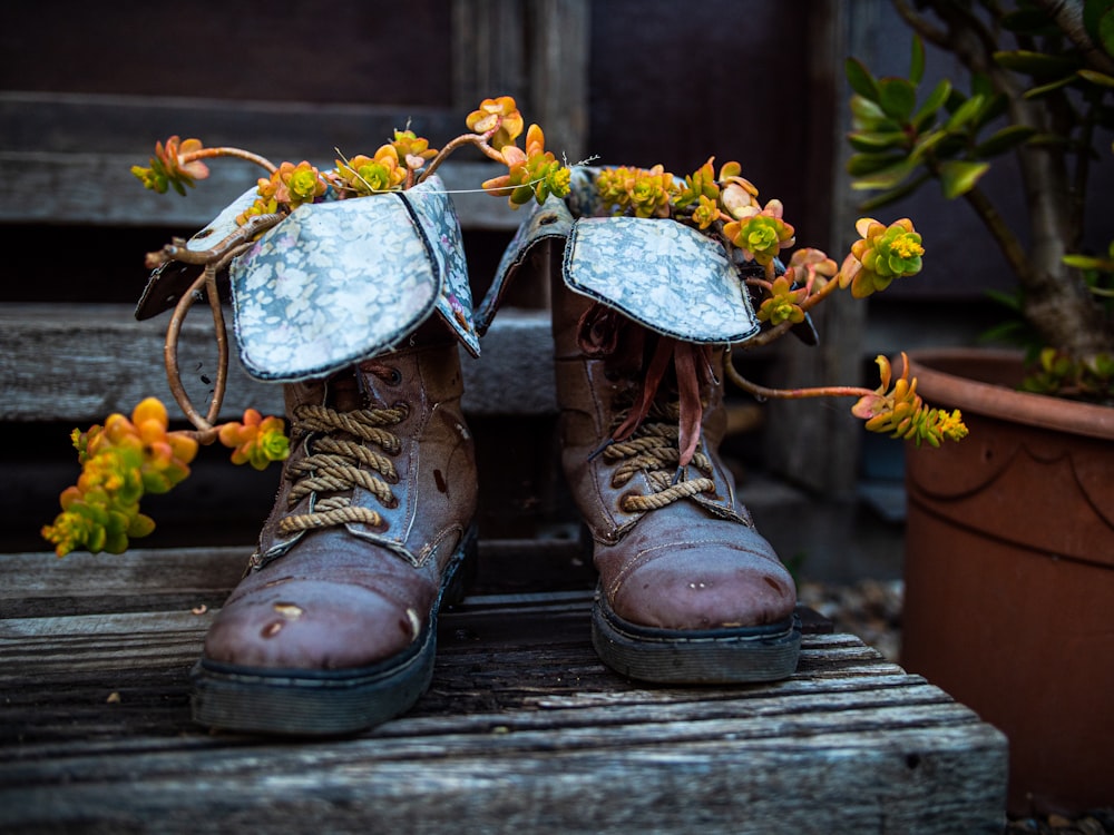 brown leather boots on wooden surface