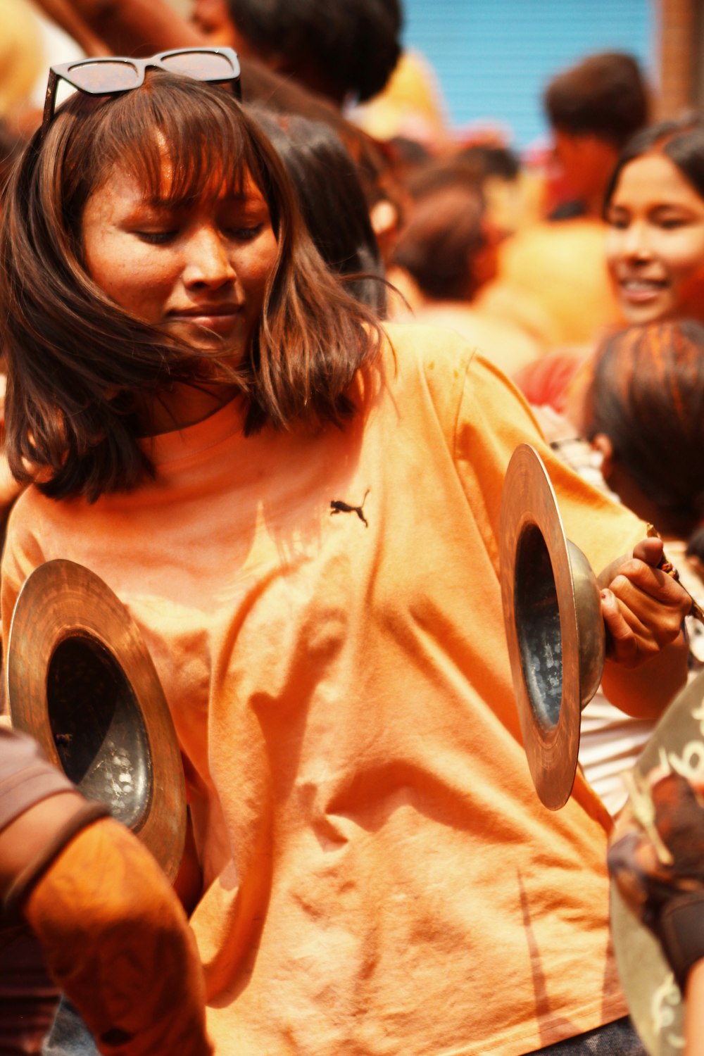 woman in orange crew neck t-shirt smiling