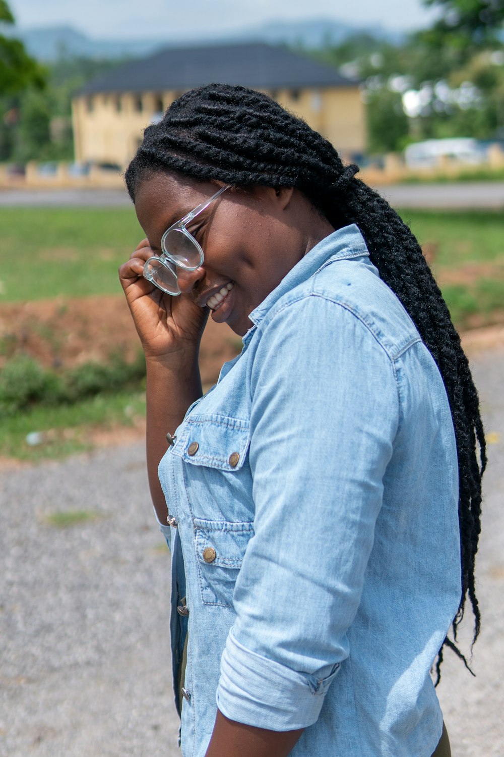 woman in blue denim button up jacket wearing black knit cap and sunglasses