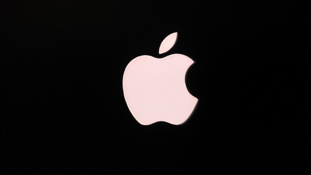 A white apple logo with a bite taken out, set against a black background. The logo is simple and iconic in design.