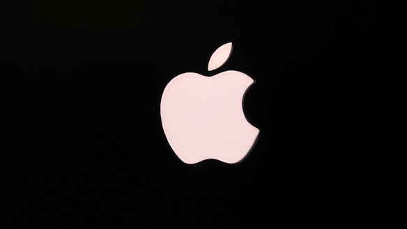 A white apple logo with a bite taken out, set against a black background. The logo is simple and iconic in design.