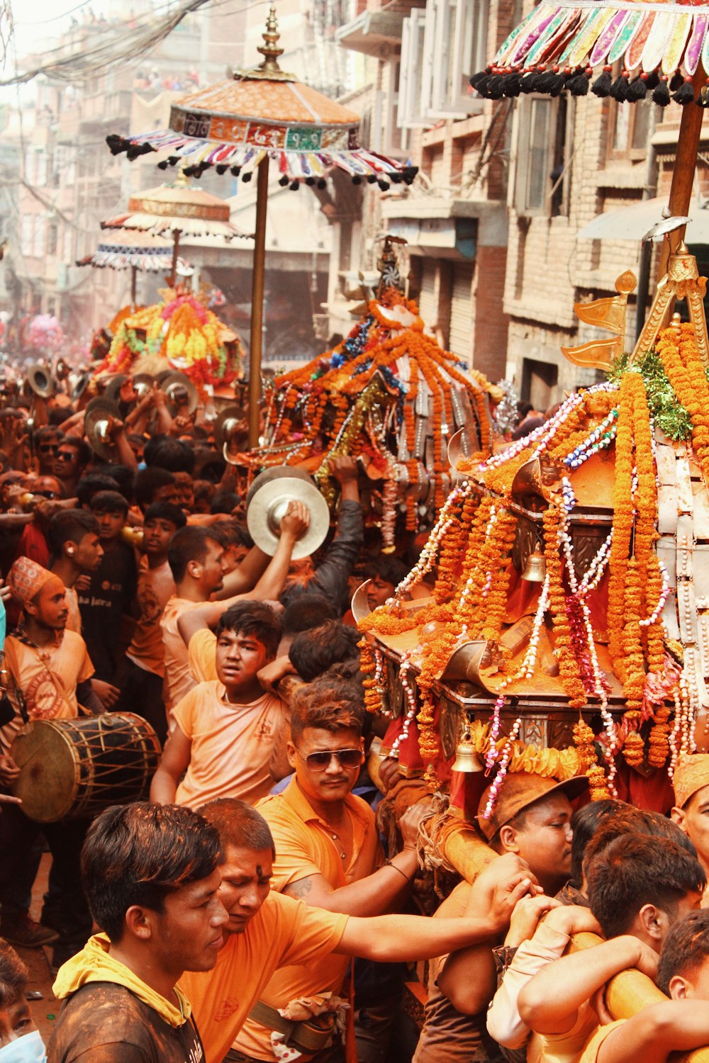 people in yellow and red costume dancing on street during daytime