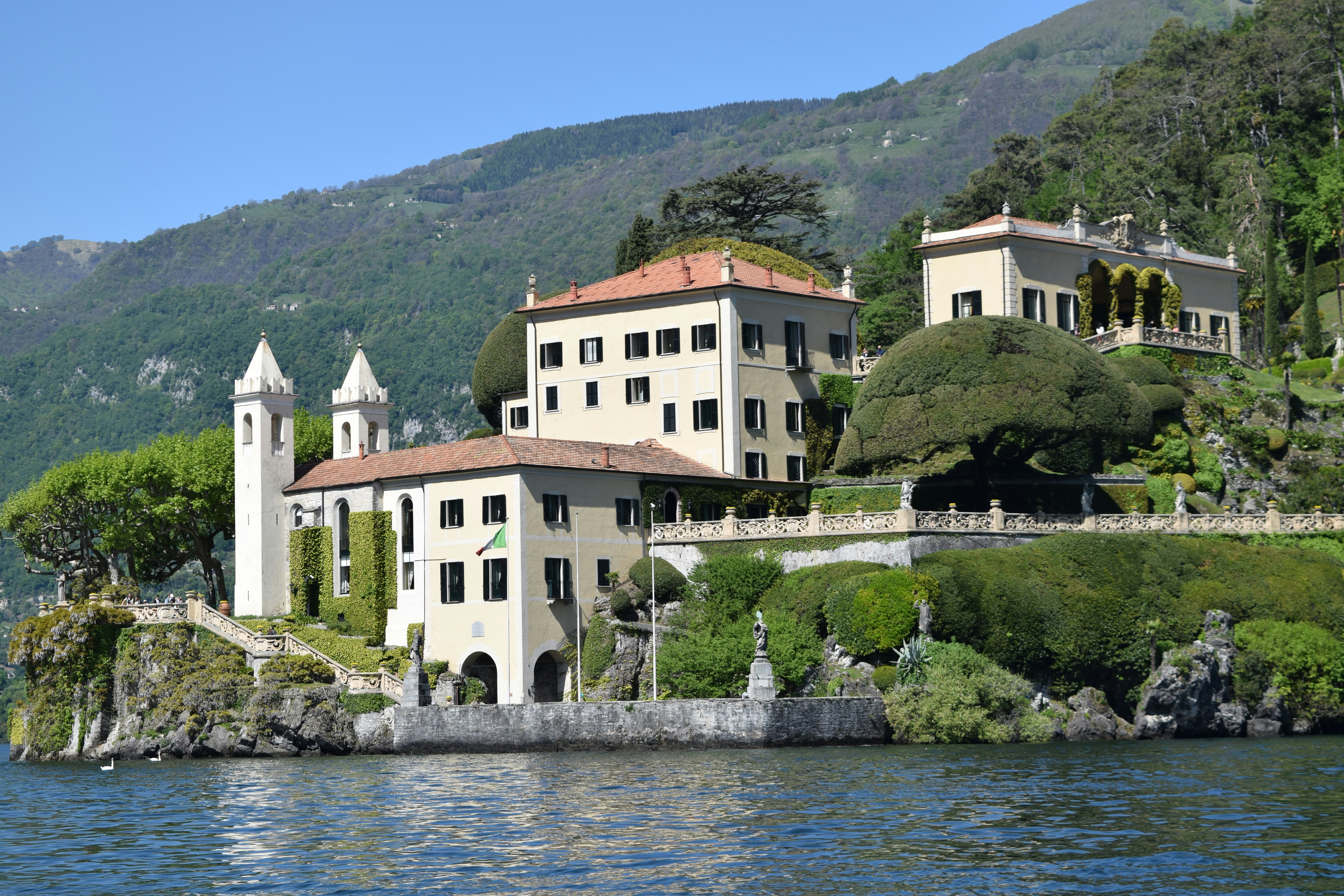 white and brown concrete building near body of water during daytime, Villa de Balbianello on Lake Como Italy