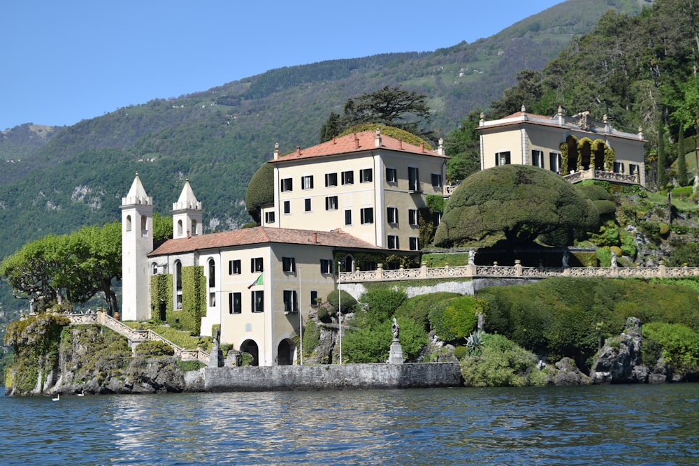 white and brown concrete building near body of water during daytime