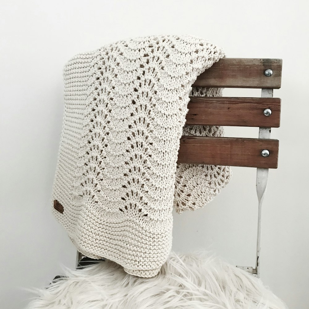 white knit textile on brown wooden chair