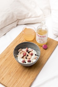 A serene morning scene with a glass of citrusburn supplement beside a bowl of fresh fruit and a yoga mat.