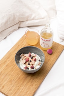 A serene morning scene with a glass of citrusburn supplement beside a bowl of fresh fruit and a yoga mat.