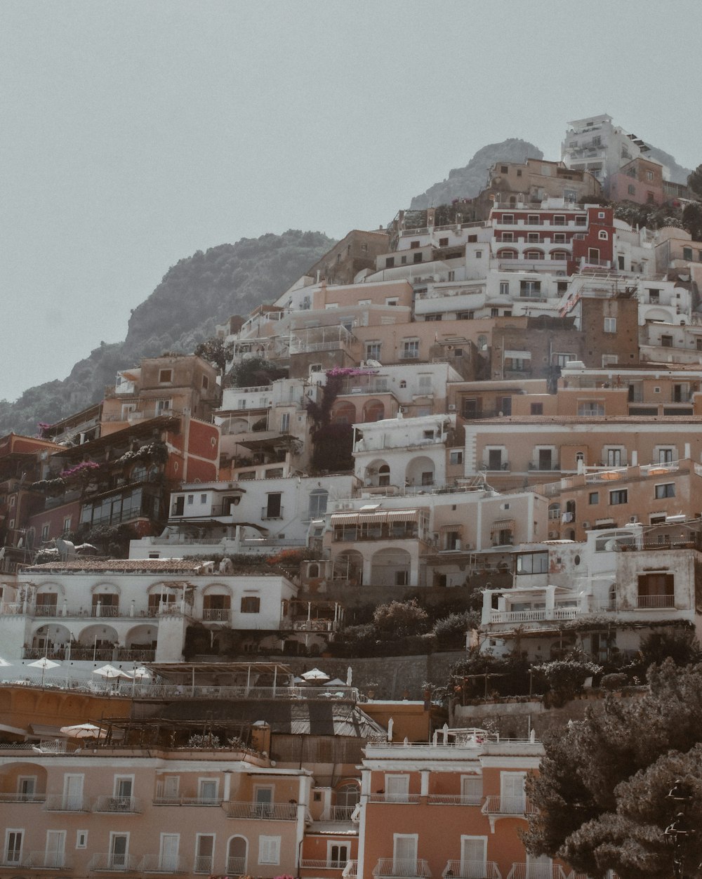edifícios de concreto branco e marrom perto da montanha durante o dia