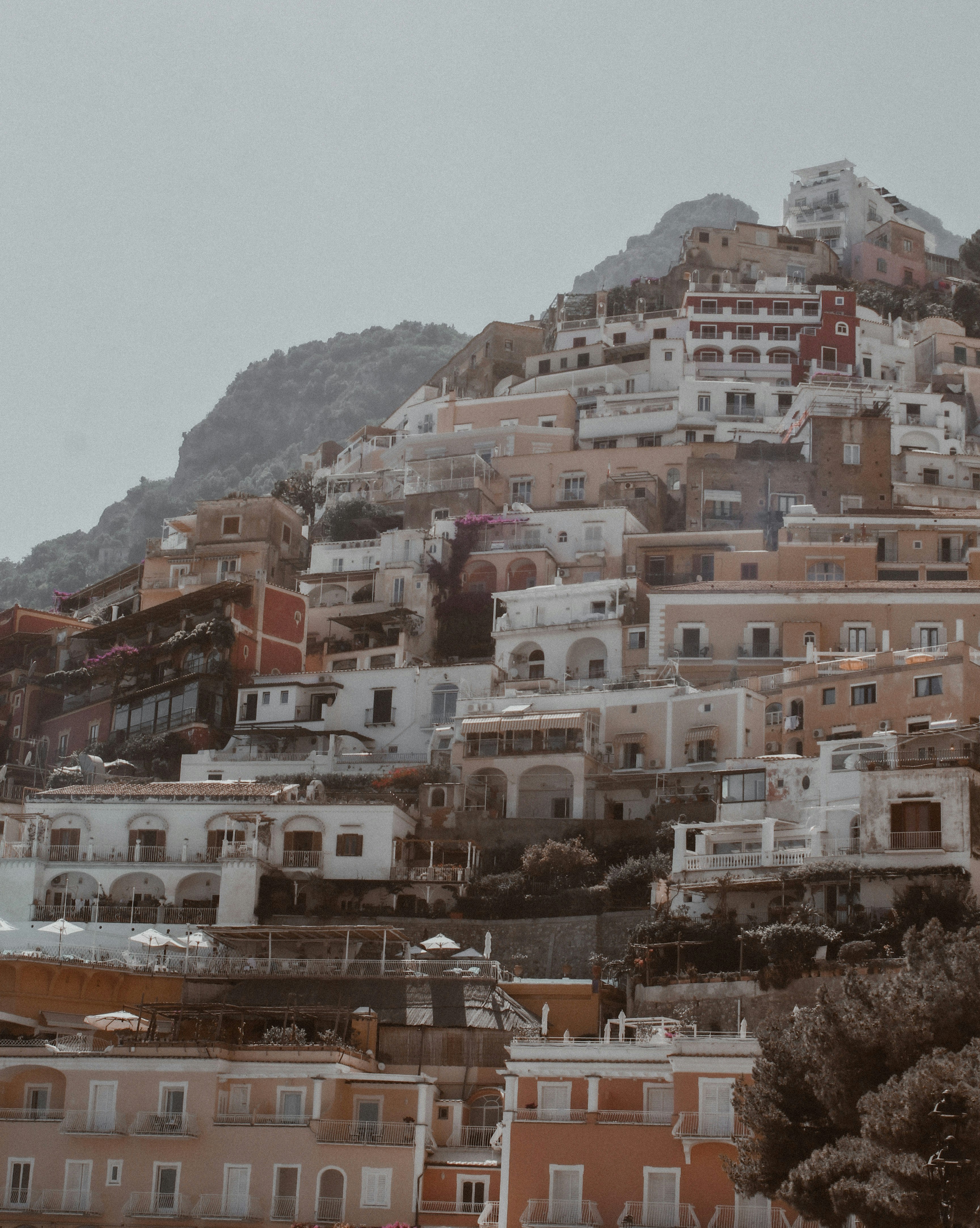 white and brown concrete buildings near mountain during daytime