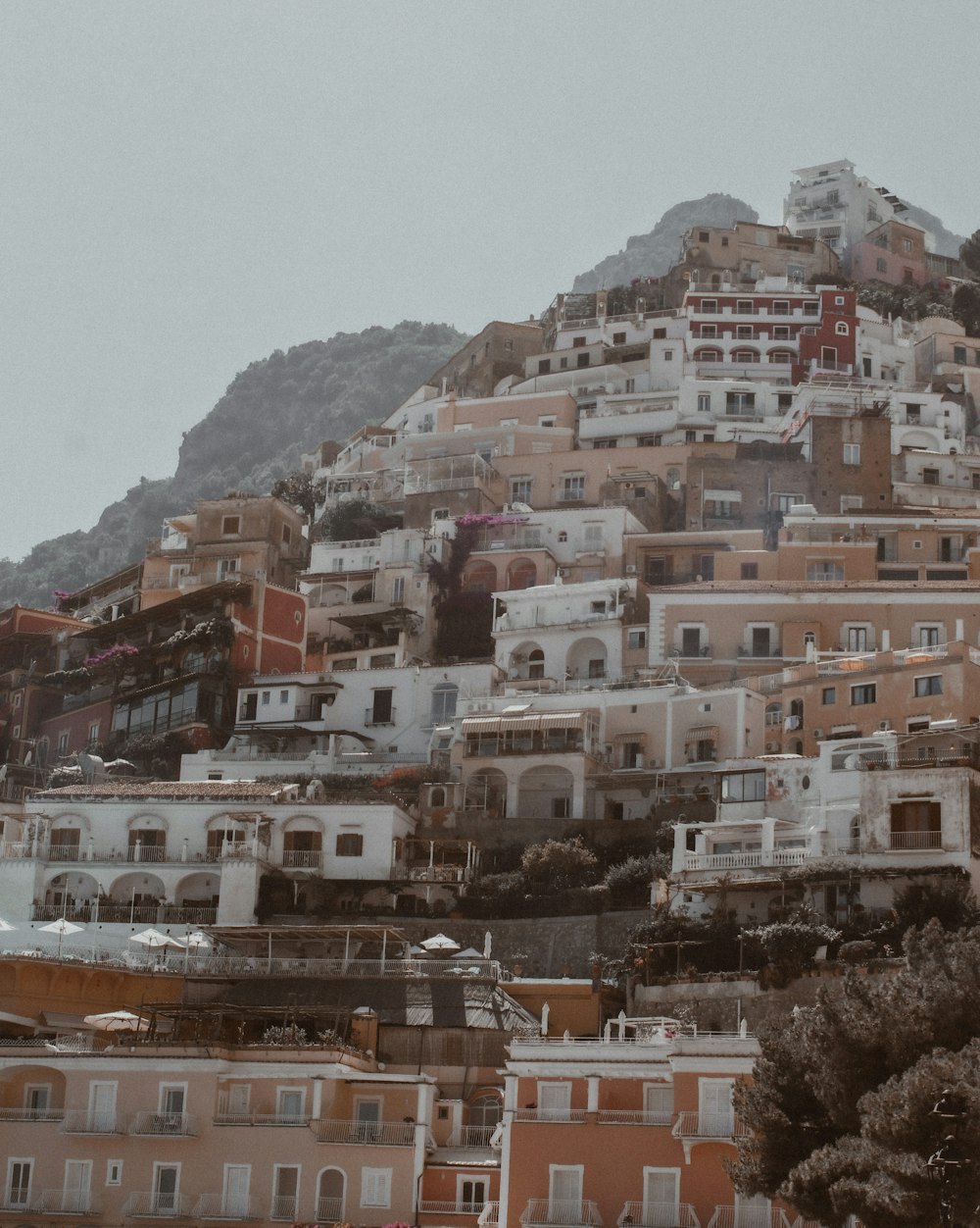 white and brown concrete buildings near mountain during daytime