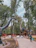 Children laughing and playing among colorful dinosaur statues in an immersive themed park.