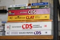 A stack of academic books focused on entrance exams such as SSB Interviews, CDS, and CLAT. The books are neatly arranged, displaying a variety of colors and fonts, each with distinct covers indicating the title and the publisher.