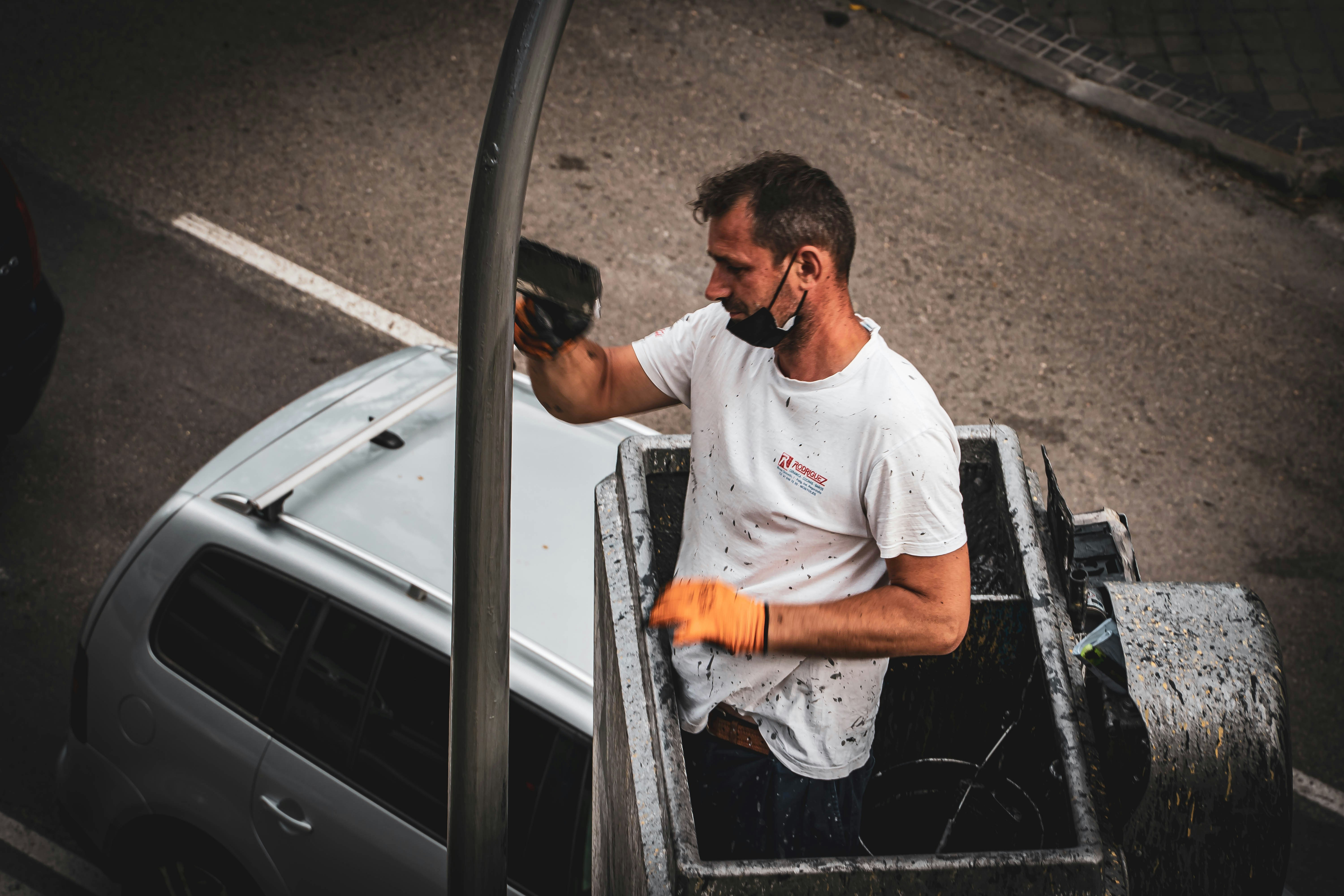 Mechanic inspecting the undercarriage and frame of a pickup truck on a lift
