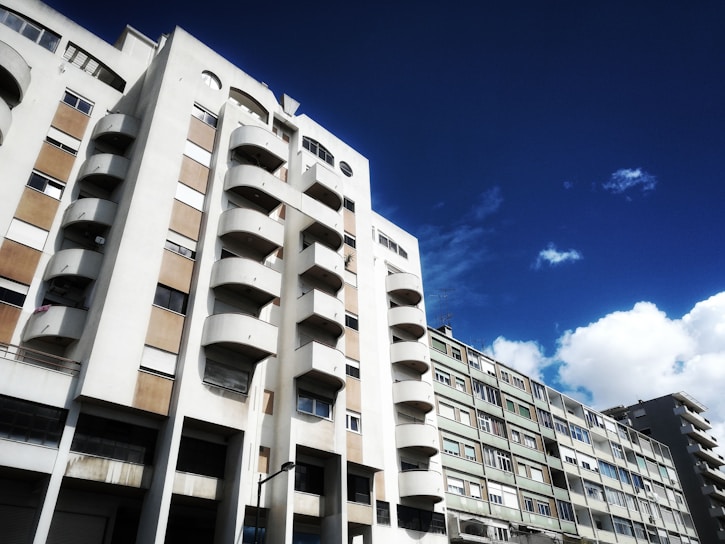 A panoramic view of Pinery Residences showcasing its sleek modern architecture against a bright blue sky.