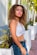 woman in white and black stripe tank top and blue denim bottoms