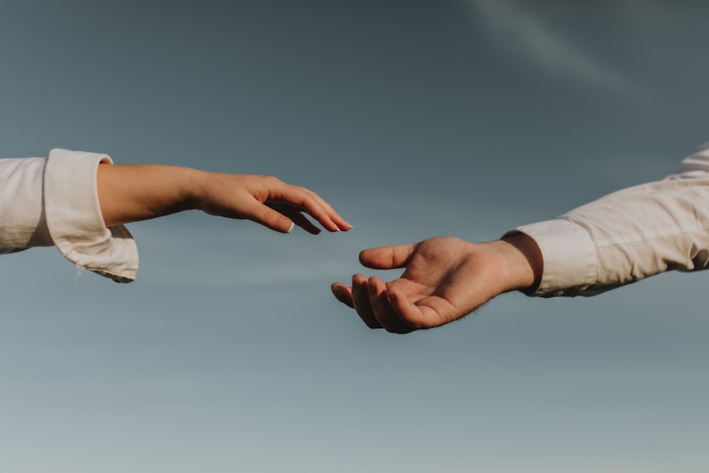 person holding white heart paper