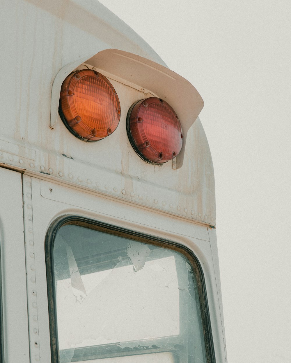 white and orange bus with light