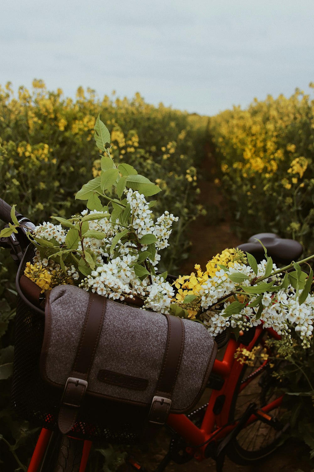 green and white flower in black leather bag