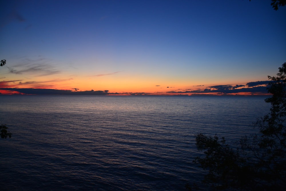 body of water during sunset