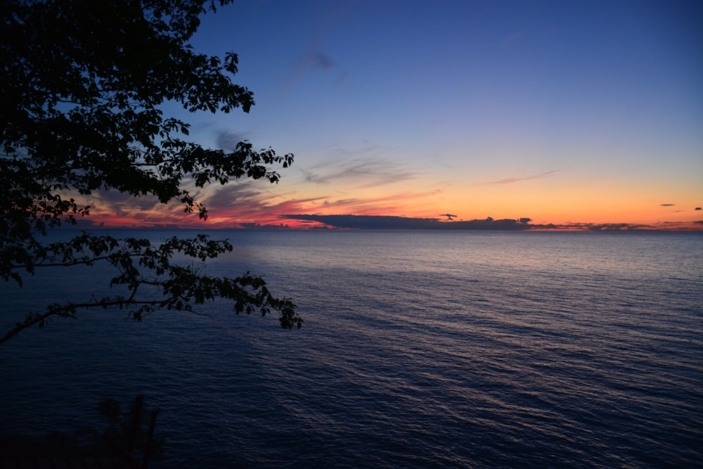 body of water during sunset