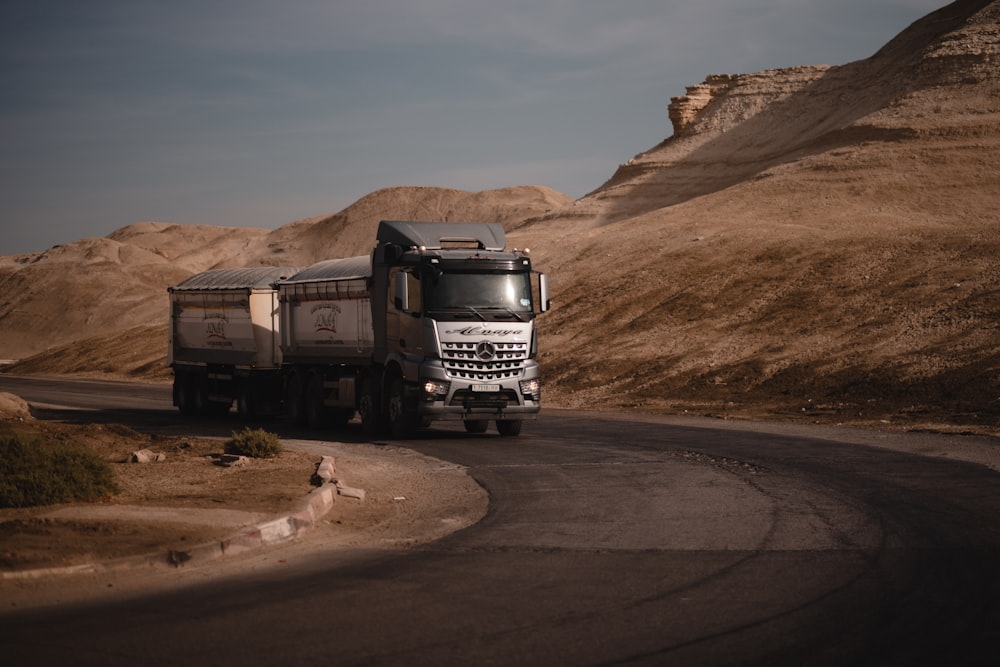 white and black truck on road during daytime