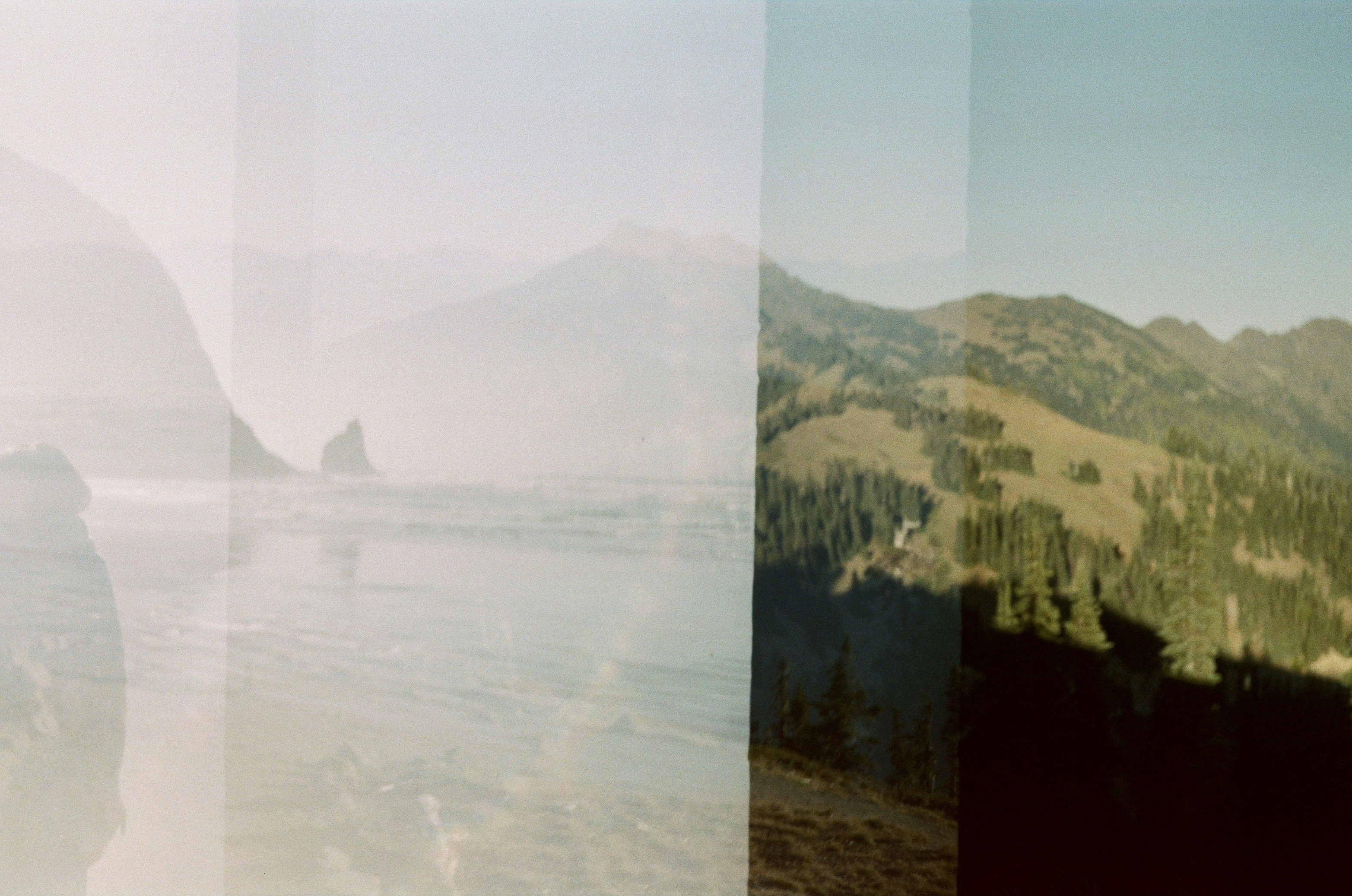 body of water near mountain during daytime