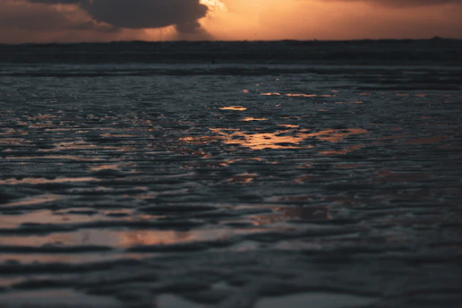 A quiet sunset over a calm sea, evoking peaceful reflection.