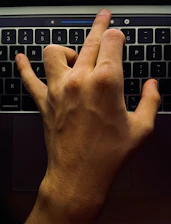 Close-up of hands adjusting accessibility settings on a laptop screen