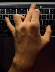 Close-up of a hand configuring cloud settings on a laptop screen.