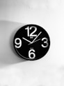 black and white analog wall clock at 10 00