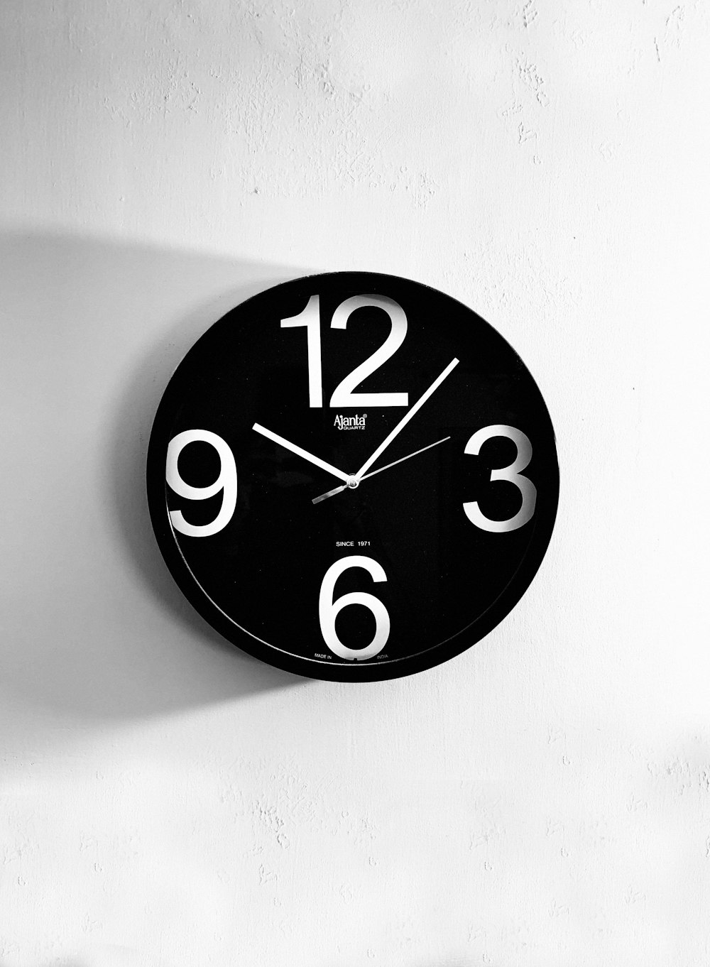 black and white analog wall clock at 10 00