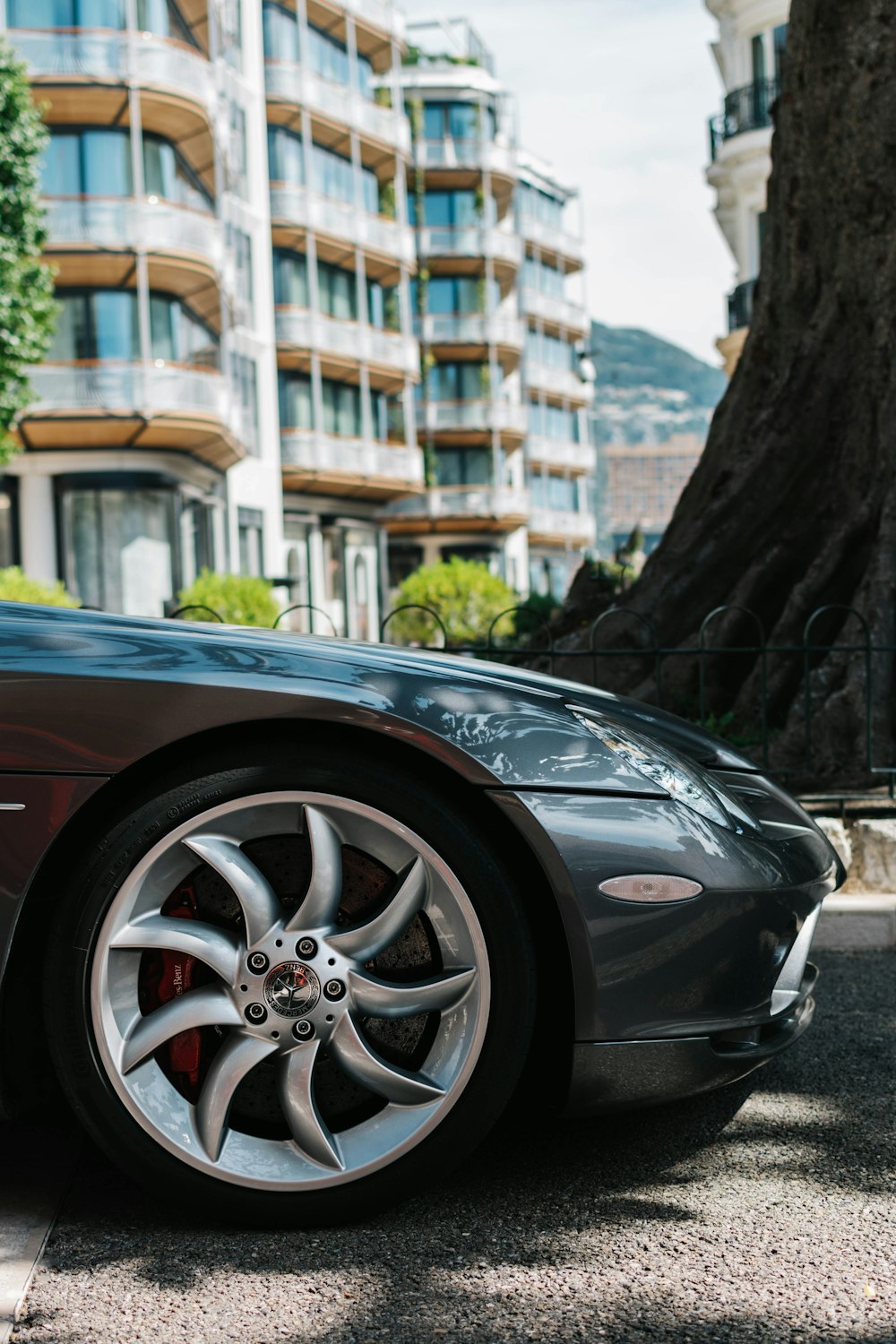 black porsche 911 parked near tree during daytime