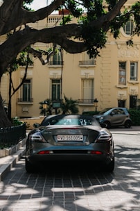 black porsche 911 parked on sidewalk during daytime