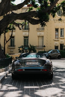 black porsche 911 parked on sidewalk during daytime