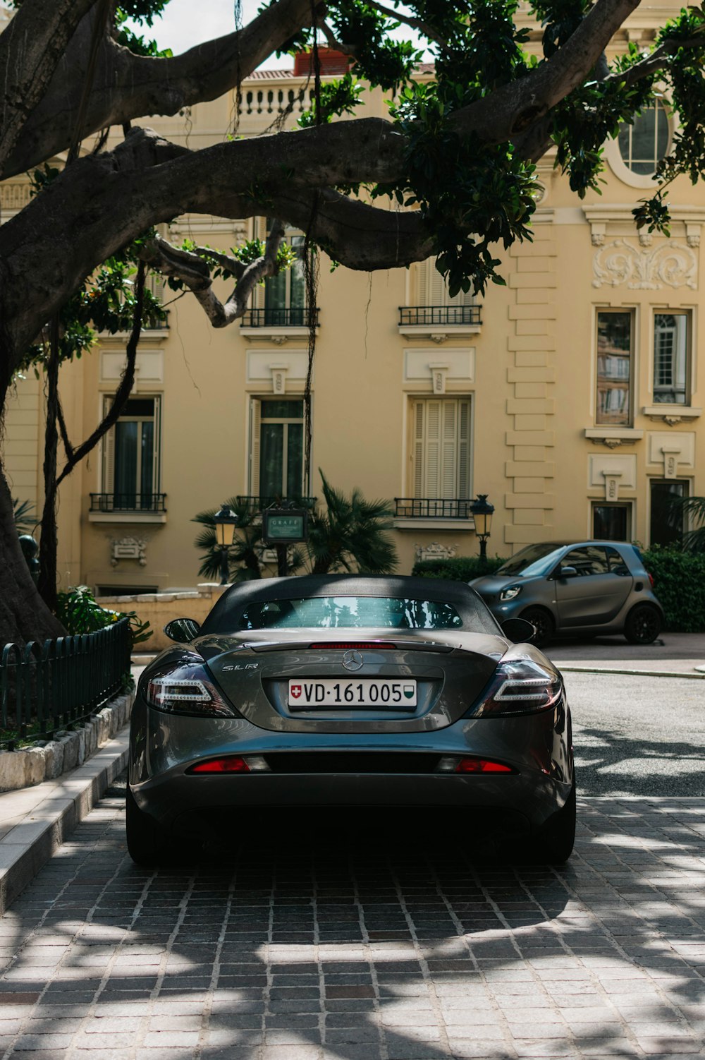 black porsche 911 parked on sidewalk during daytime