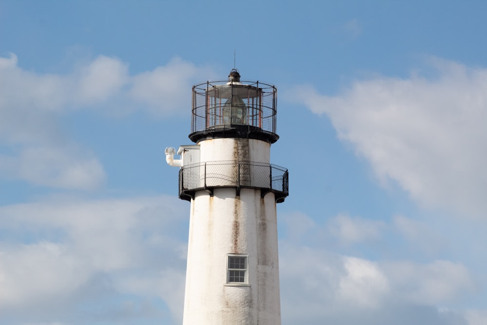 white and black lighthouse under blue sky during daytime