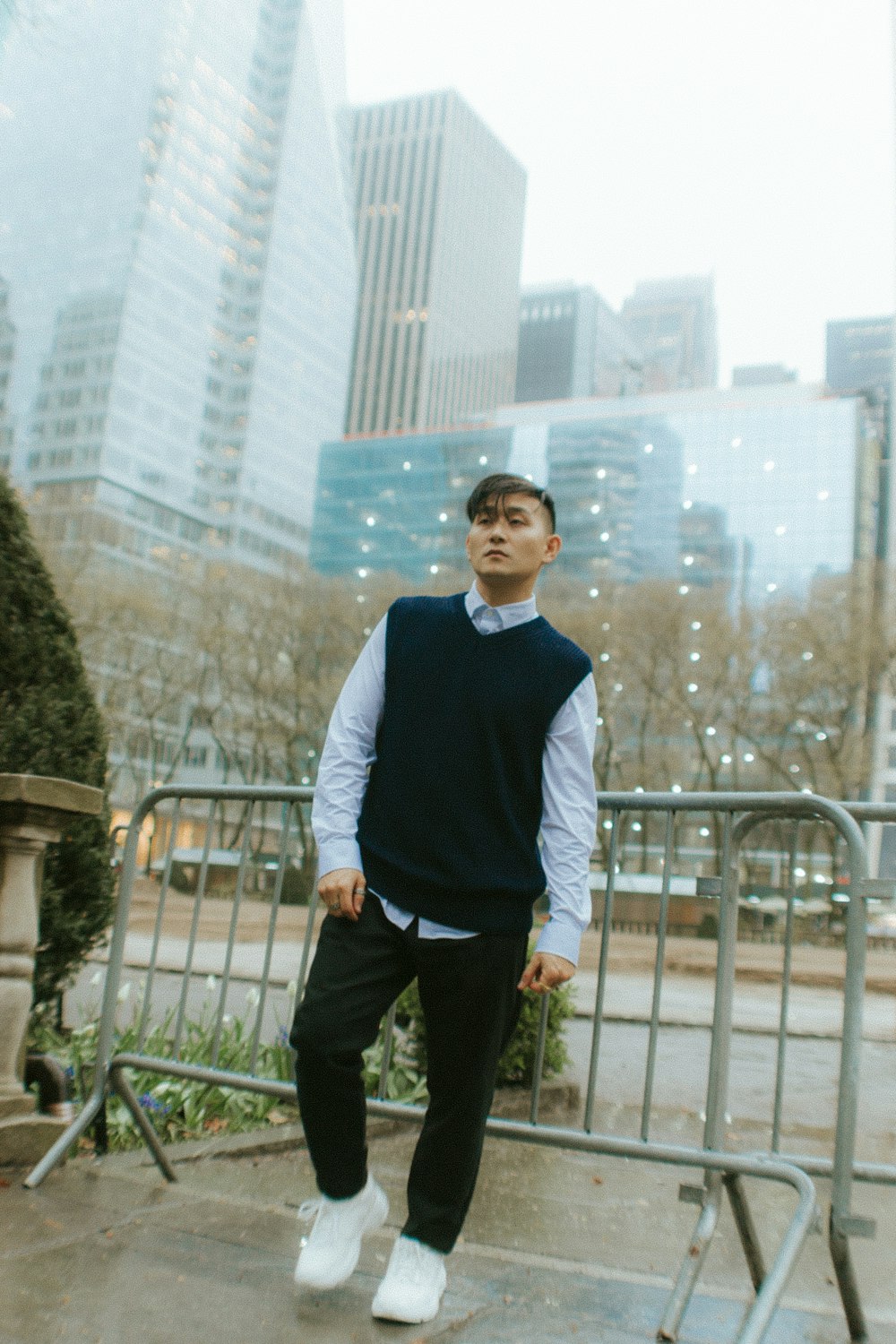 man in blue sweater standing near railings