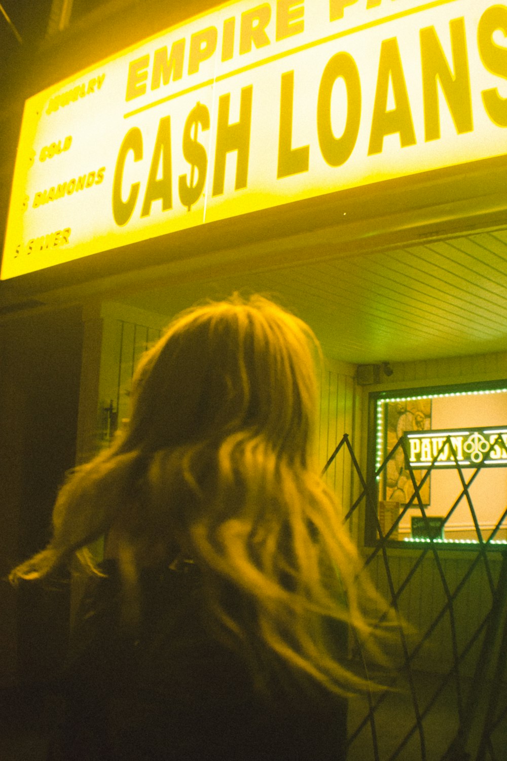 a woman standing in front of a casino sign
