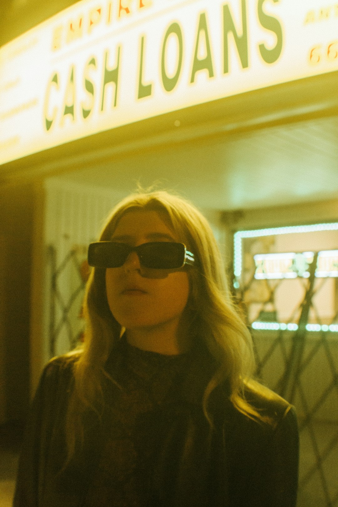 woman in black sunglasses and brown shirt