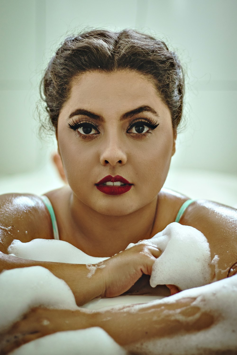 woman in white tank top holding white textile