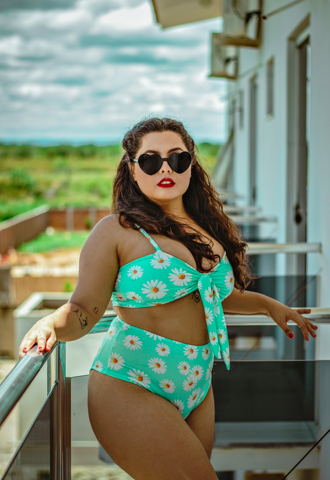 woman in blue and pink polka dot bikini top wearing black sunglasses