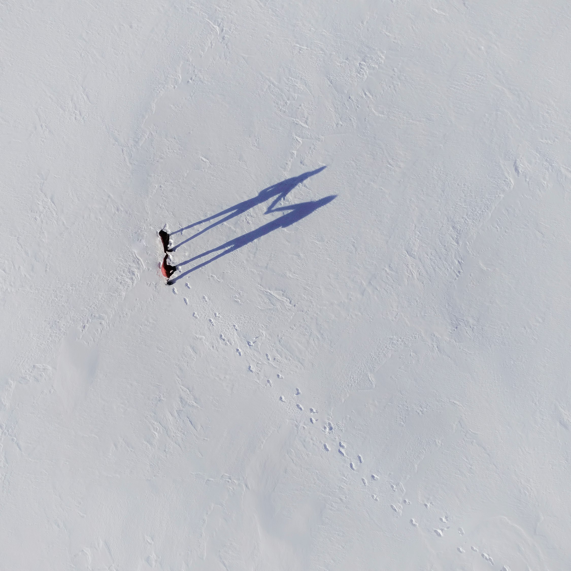 person walking on snow covered field during daytime