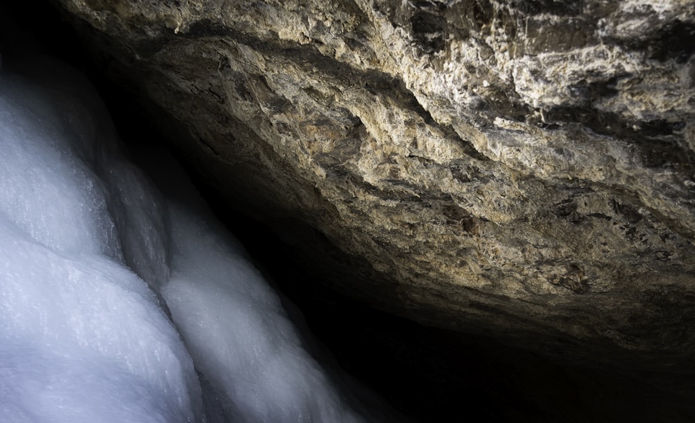 brown rock formation with water falls