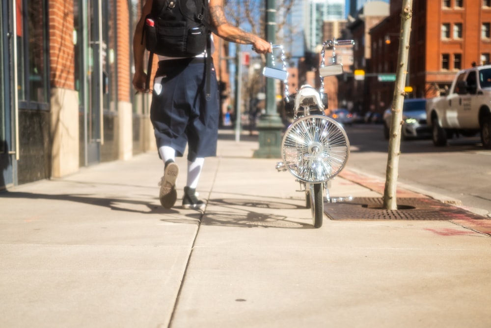 man in black t-shirt and blue denim jeans playing basketball during daytime