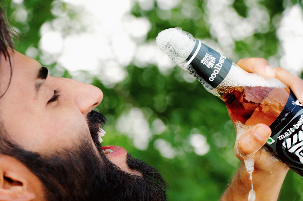 man drinking on a bottle