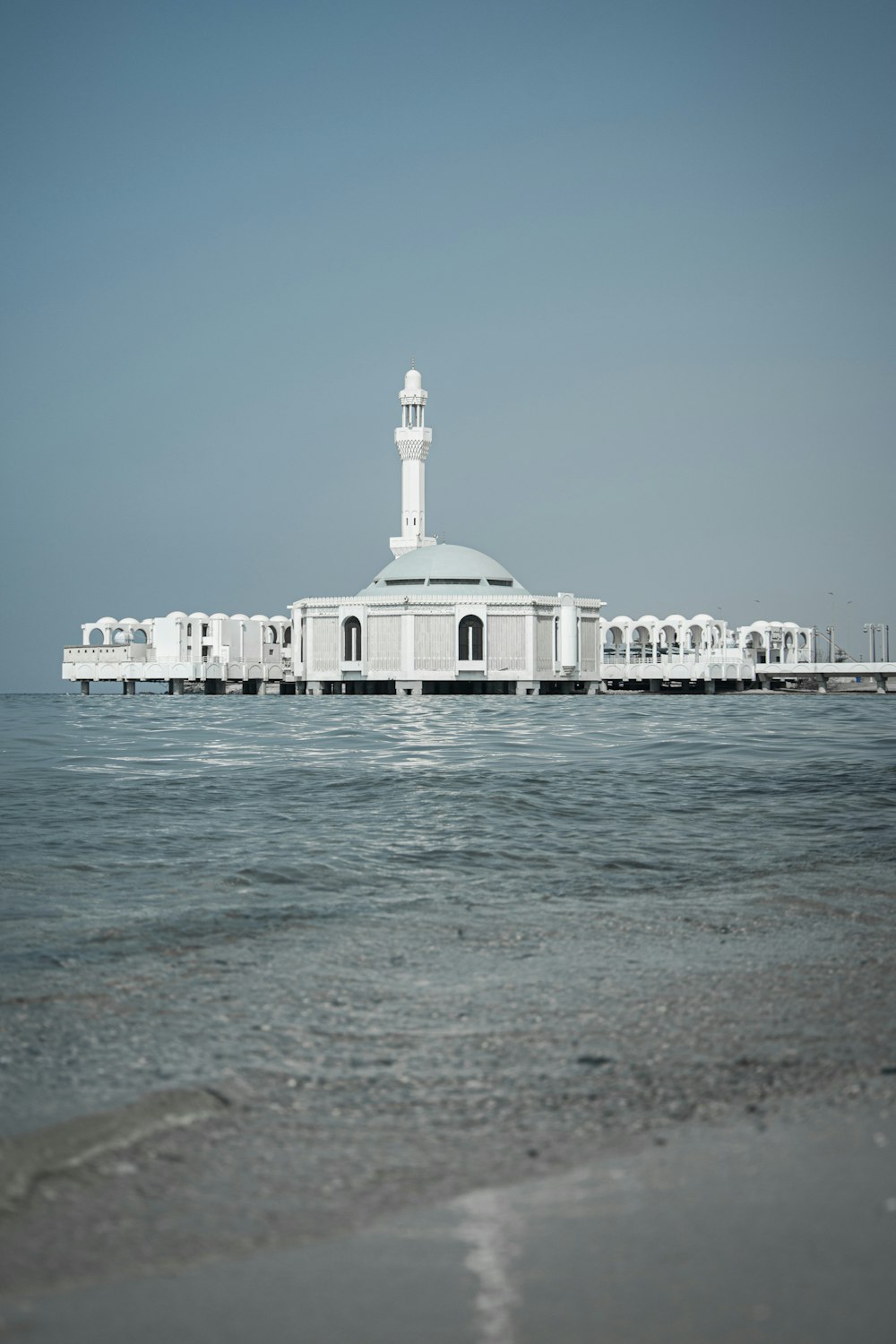 white concrete building near sea during daytime