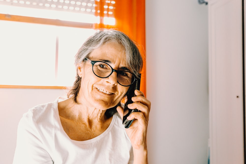 woman in white scoop neck shirt wearing black framed eyeglasses