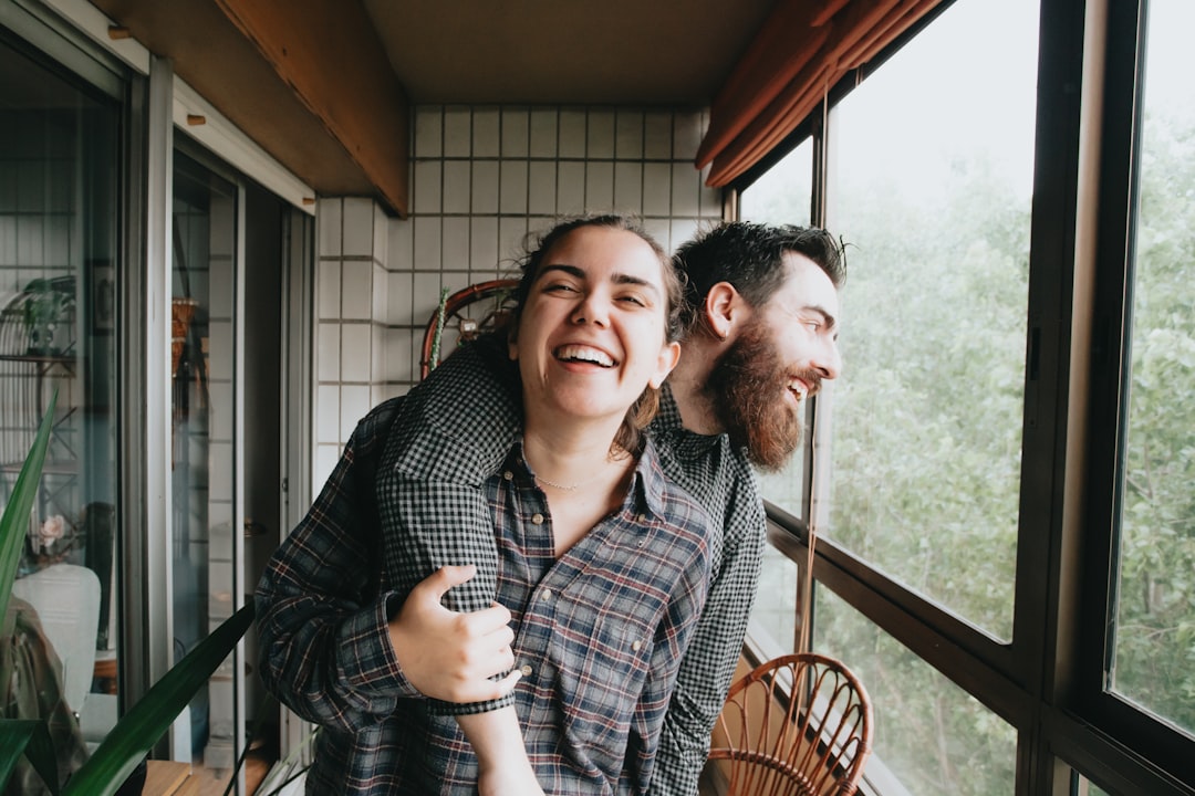 man and woman sitting on chair